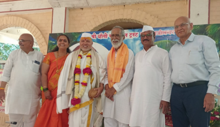 Dignitaries felicitating a trustee at a Rishivalley Pyramid camp inauguration